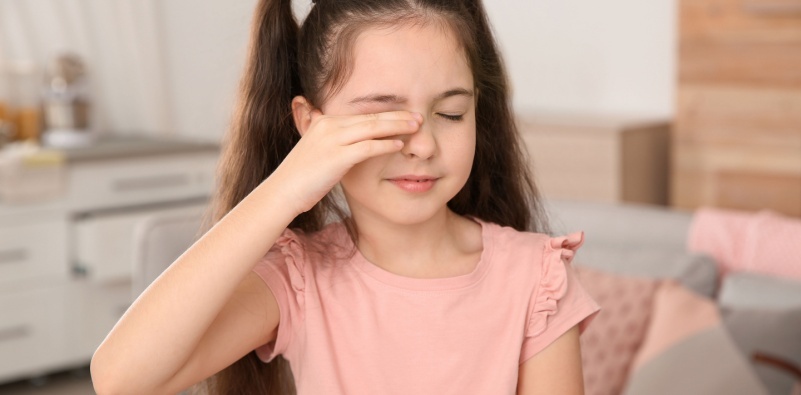Kid rubbing her eye