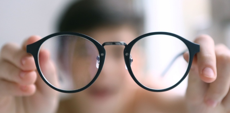 kid holding eyeglass 